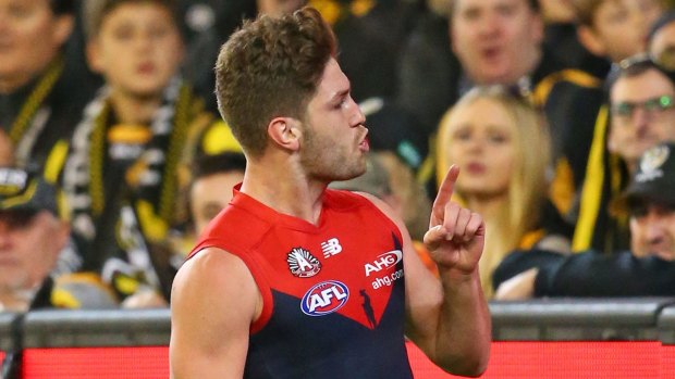Melbourne's Tom Bugg gestures to Tigers supporters on Sunday night.