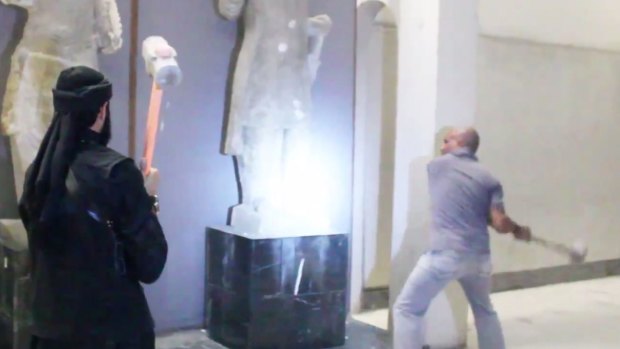 Militants attack ancient artefacts with sledgehammers in a video distributed by the group.