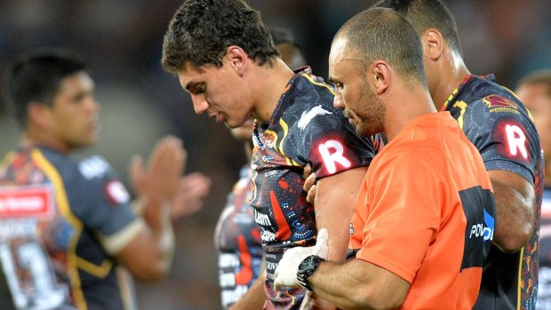 Kyle Turner of the Indigenous All Stars is assisted from the field by medical staff after being hit high in a tackle by Paul Gallen.