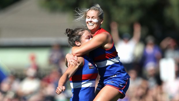 Dogs have their day: Katie Brennan celebrates with teammate Elle Blackburn after scoring the Bulldogs' third goal.