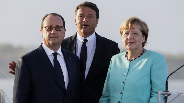 From left: French President Francois Hollande, Italian Prime Minister Matteo Renzi and German Chancellor Angela Merkel aboard the Italian aircraft-carrier Giuseppe Garibaldi.