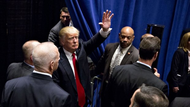 Donald Trump waves as he leaves following a campaign event in South Bend, Indiana.