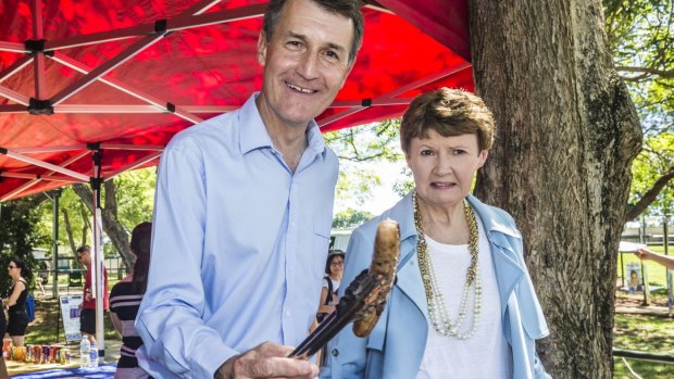 Lord Mayor Graham Quirk steps up to the sausage sizzle as he heads to the polls with his wife Anne at Warrigal Road State School.