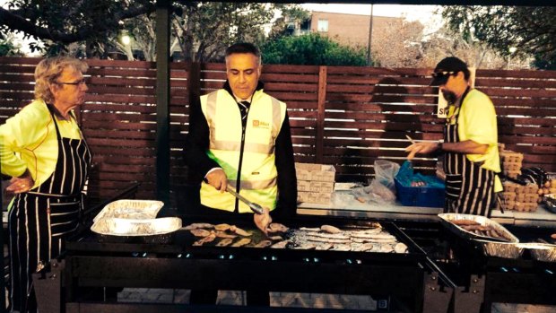Australia Post chief executive Ahmed Fahour helping out at a staff barbecue. 