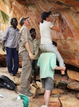 Melbourne University scientists Helen Green, Jordy Grinpukel, traditional owners Mark Unghango, Ernie Boona and Damien Fink sampling a hard-to-reach mineral crust. 