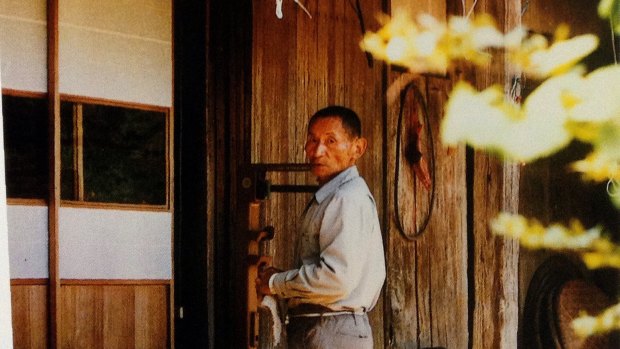 Tatsuo Yamamoto at his home where he kept a flame from the Hiroshima atomic bomb for 23 years. 