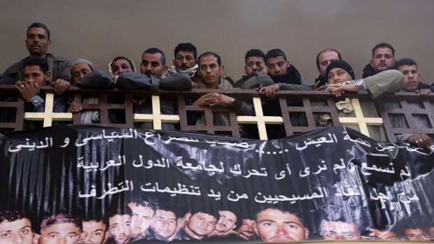 Friends and family of Egyptian Coptic Christian men killed by Islamic State in Libya attend a church service.