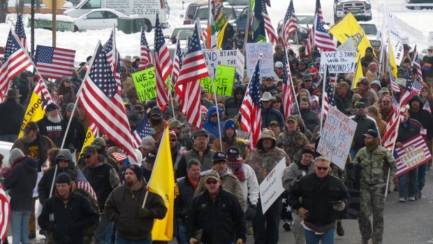 Protesters march in support of an Oregon ranching family facing jail time for arson in Burns, Oregon, ahead of the militant takeover of a federal building. 