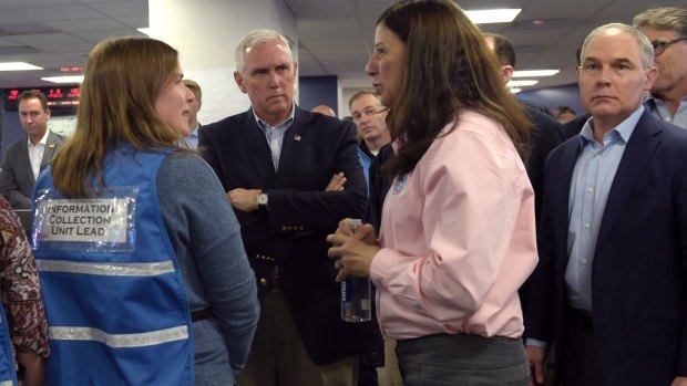 Environmental Protection Agency Administrator Scott Pruitt, right, and US Vice President Mike Pence, centre, during a visit to FEMA headquarters in Washington on Sunday.