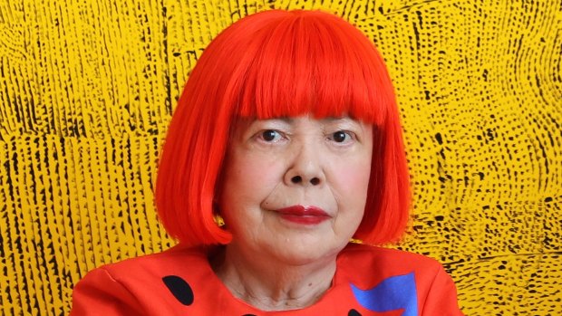 Yayoi Kusama in front of Peace Shall Come as Far as the Ends of the Universe (2017).