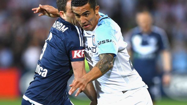 Caught in the middle: Tim Cahill.