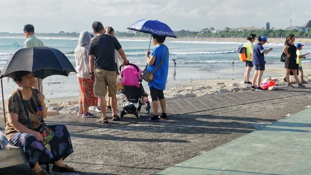 Chinese tourists at Kuta Beach in Bali.