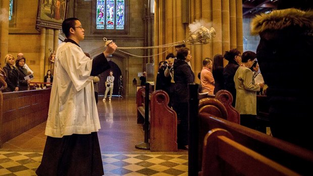 The mass at St Mary's Cathedral was a solemn affair.