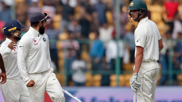 India's captain Virat Kohli, second right, gestures to Australia's Josh Hazlewood after their win.