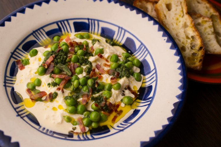 Stracciatella with peas, pancetta, salmoriglio and pangratto at Ode.