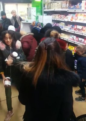 In this image taken from video a customer carries away pots of Nutella as others congregate around display of the product in a supermarket in Toulon, southern France.