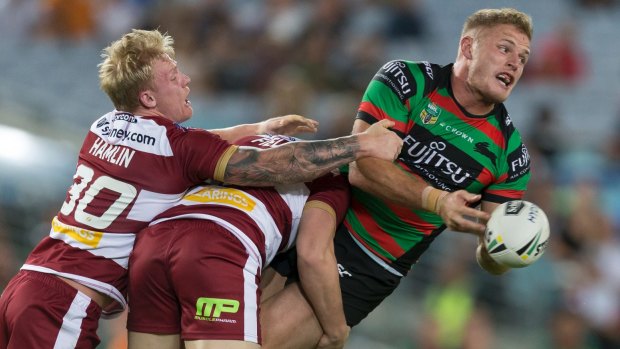 Air time: Thomas Burgess offloads despite pressure from two defenders.