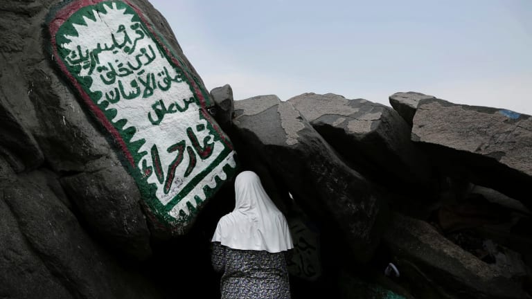 A Turkish Muslim woman prays inside Hiraa cave, where Prophet Muhammad received his first revelation from God to preach Islam, on Noor Mountain, on the outskirts of Mecca, Saudi Arabia.