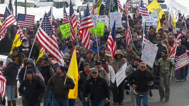 Protesters march in support of an Oregon ranching family facing jail time for arson in Burns, Oregon, ahead of the militant takeover of a federal building. 