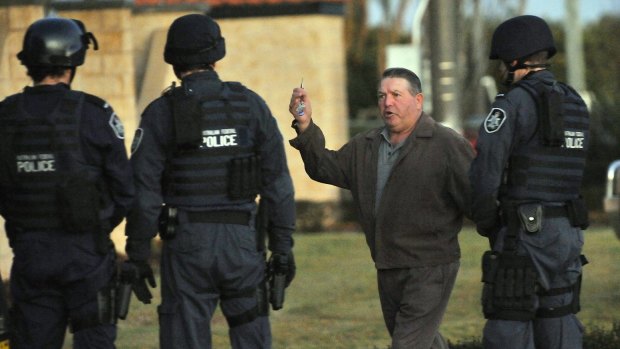 Francesco 'Little Trees' Barbaro confronts AFP officers outside his son Pat's Griffth property.