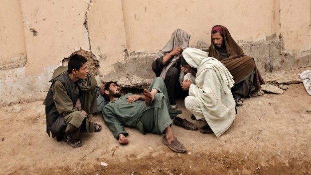 Addicts gather to smoke heroin at a park in Lashkar Gah, Helmand Province, Afghanistan.