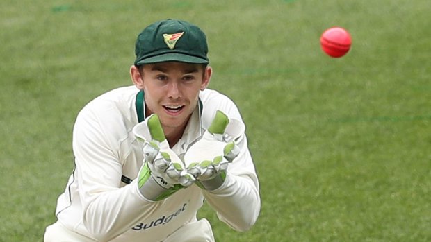 Tasmanian wicketkeeper Jake Doran with the new pink ball in use in the Sheffield Shield match at the MCG on Tuesday.