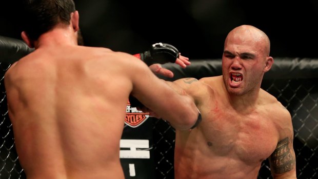 Robbie Lawler trades blows with Johny Hendricks in their welterweight title fight during UFC 181.