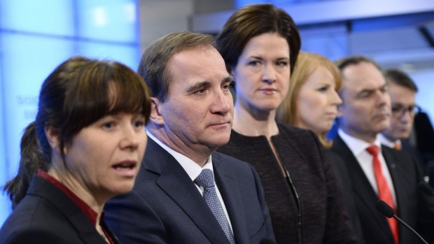 Partners: Deputy Prime Minister Asa Romson, Prime Minister Stefan Lofven and members of the centre-right Alliance announce the power-sharing deal in Stockholm on Saturday.