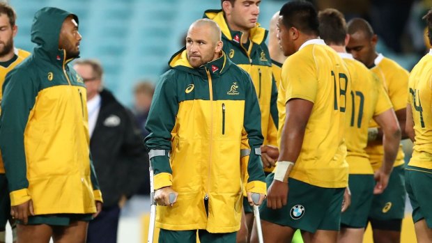 Miserable outing: Matt Giteau hobbled out of ANZ on crutches.