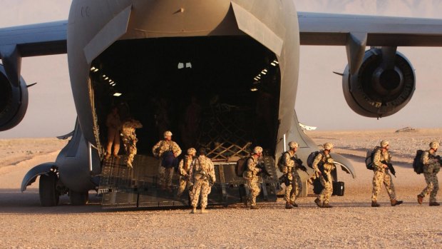Members of the Australian Special Operations Task Group disembark a United States Air Force C-17 Globemaster at a base in Afghanistan.