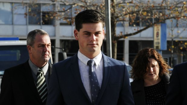 ADFA cadet Jack Toby Mitchell arrives at the ACT Supreme Court for the first day of his rape trial on Monday with his mother and father.
