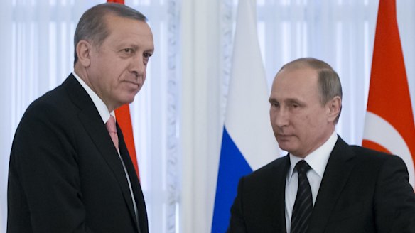 Russian President Vladimir Putin, right, and Turkish President Recep Tayyip Erdogan shake hands at a news conference after their talks in the Konstantin palace outside St.Petersburg in Russia.