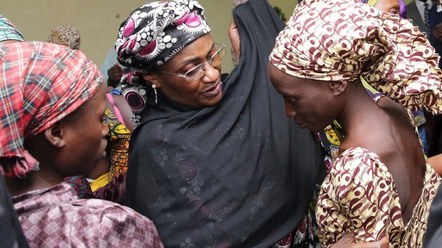 A girl freed from Boko Haram is met by a Nigerian government official in Abuja in October.