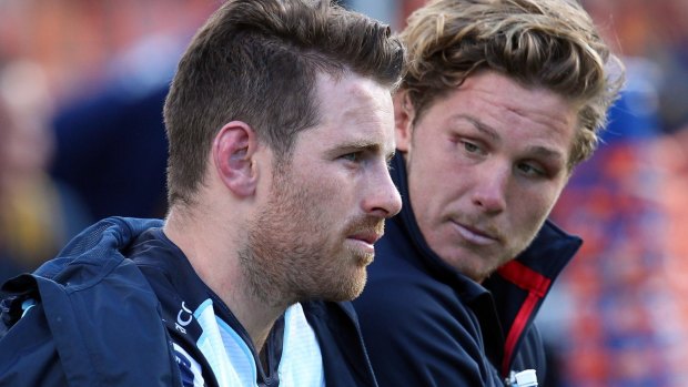 Bernard Foley of the Waratahs sits forlornly on the bench with Michael Hooper after injuring his shoulder. 