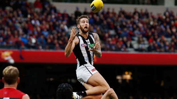 Jeremy Howe of the Magpies marks the ball over Tom McDonald of the Demons.