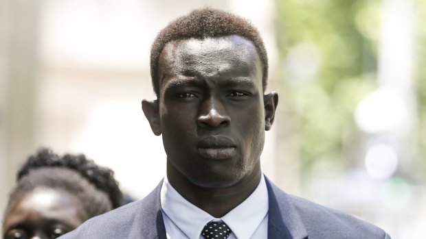 North Melbourne player Majak Daw arrives at the County Court.