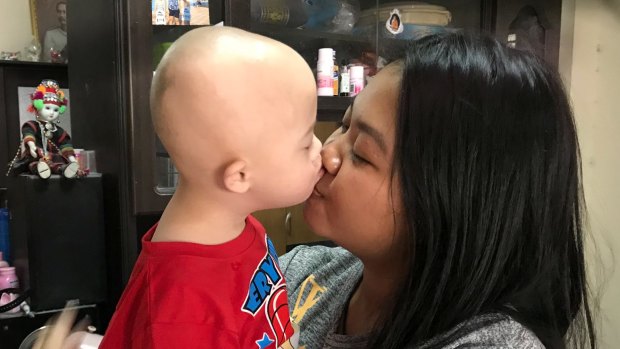 Gammy gets a birthday kiss from his mother Pattaramon "Goy" Chanbua.