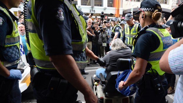 One man in a mobility scooter tried to ram a police car as the homeless were moved on from Flinders Street.