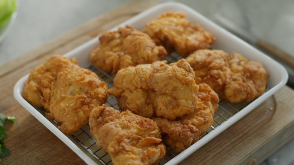 Danielle Alvarez rests her buttermilk fried chicken on a cooling rack over a baking tray. See the recipe in the video below.
