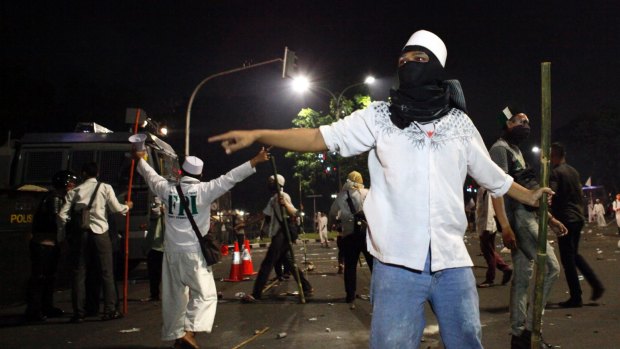 Protesters clash with police at the end of an anti-Ahok rally in Jakarta in November.  