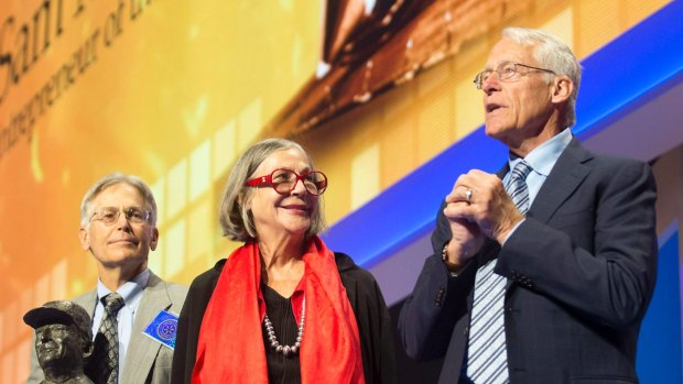Jim Walton (from left), Alice Walton and Rob Walton talk on stage during the annual Wal-Mart shareholders  meeting in June.