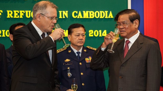 Former Immigration Minister Scott Morrison and Cambodian Interior Minister Sar Kheng toast the $40 million agreement last year.