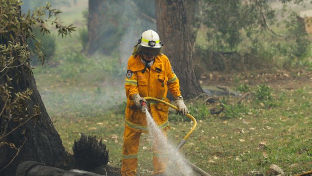 Fire fighters attend a property along Cabbage Tree Road, Williamtown, on Saturday.