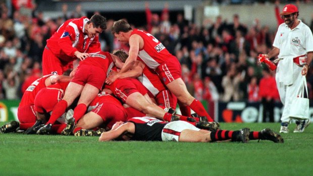 Perfect point: Sydney Swans players swamp Tony Lockett after he kicked the winning point against Essendon 20 years ago.