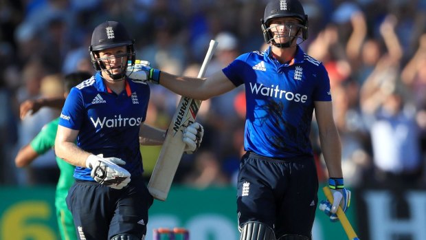 Happy days: England's Jos Buttler, right, and Eoin Morgan celebrate the milestone.