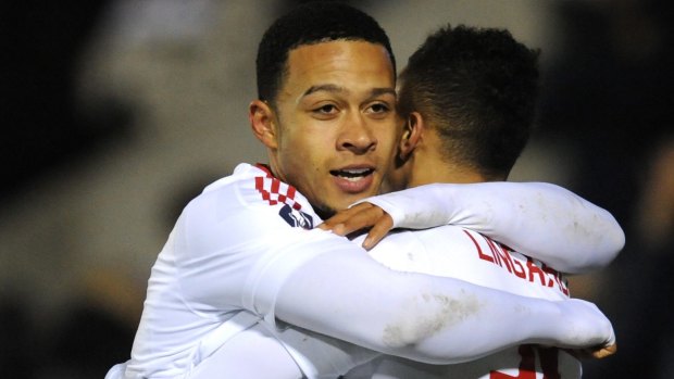 Jesse Lingard, right, is congratulated by Memphis Depay.