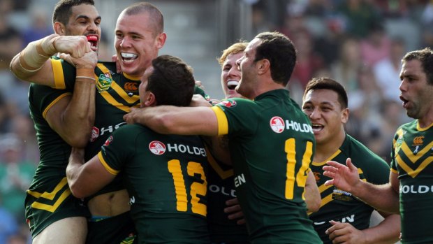 Time to celebrate: David Klemmer is congratulated by his Kangaroos teammates after scoring his first try for Australia.