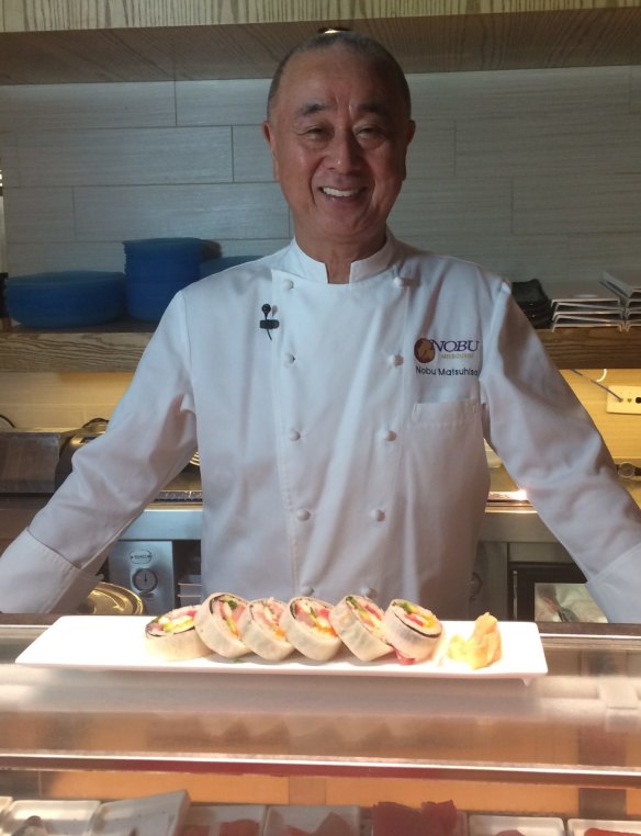 Chef Nobu poses with his Melbourne cut sushi roll.