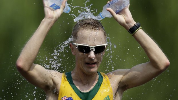Australia's Jared Tallent  douses himself with water