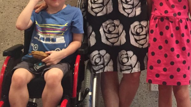 William, pictured with his grandmother and sister, has Duchenne muscular distrophy and the wheelchair helps him maintain enough energy to play.